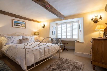 A double bedroom with a window seat at Sweet Shop Cottage, Somerset
