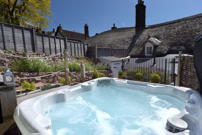 The garden with a hot tub at Sweet Shop Cottage, Somerset