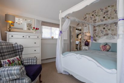 A bedroom with a four-poster bed at Sweet Shop Cottage, Somerset