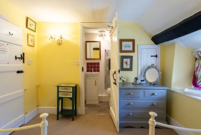 A twin bedroom with beams at Sweet Shop Cottage, Somerset