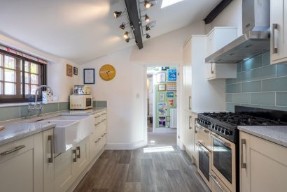 The galley kitchen leading to the hallway at Sweet Shop Cottage, Somerset