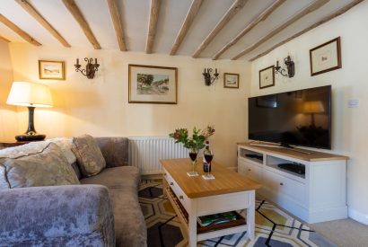 The living room with a sofa and coffee table at Sweet Shop Cottage, Somerset