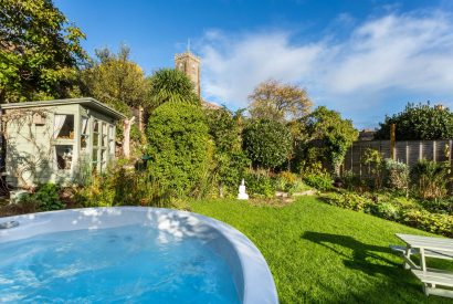 The garden with a hot tub and summer house at Thatch Corner, Somerset