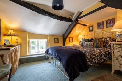 A double bedroom with beams at Thatch Corner, Somerset