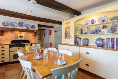 The kitchen with a large dining table at Thatch Corner, Somerset