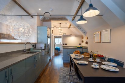 The galley kitchen with a dining table at Exmoor Barn, Somerset