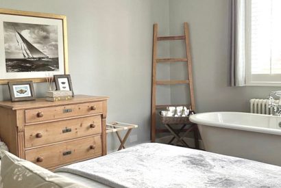 A double bedroom with free standing bath at Brickworks and Vines, Isle of Wight