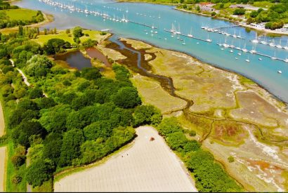 The surrounding countryside and sea, with boats at Brickworks and Vines, Isle of Wight