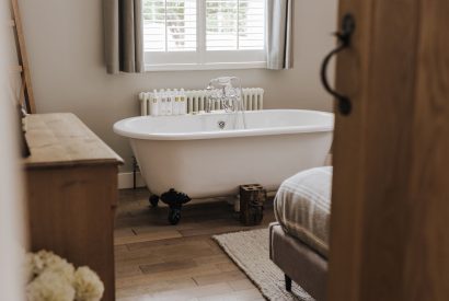 A double bedroom with a free standing bath at Brickworks and Vines, Isle of Wight