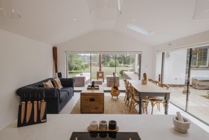 The open-plan living, dining and kitchen leading to the garden at Brickworks and Vines, Isle of Wight