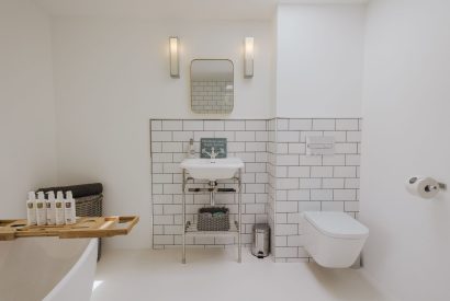 A family bathroom with free standing bath at Brickworks and Vines, Isle of Wight