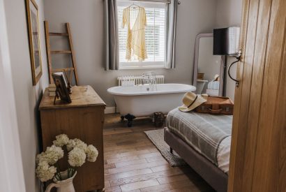 A double bedroom with a free standing bath at Brickworks and Vines, Isle of Wight