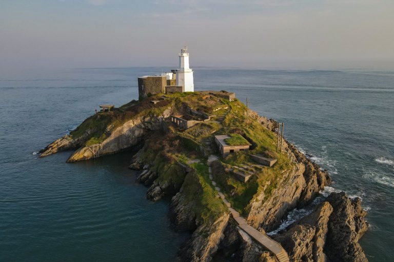 Lighthouse on a small island in the sea off Mumbles on Gower Peninsula