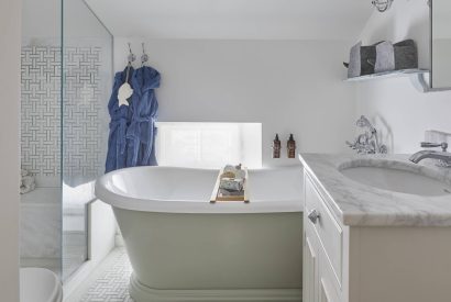 A bathroom with roll top bath at The Beach House, Devon