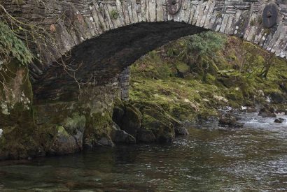 A bridge over a river at Beatrix Cottage, Lake District