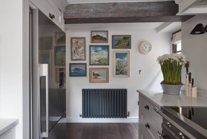 The kitchen with pictures at Beatrix Cottage, Lake District