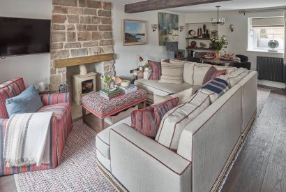 The living and dining room with log burner at Beatrix Cottage, Lake District