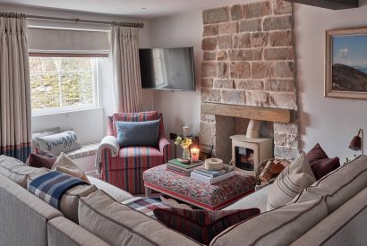 The living room with log burner at Beatrix Cottage, Lake District