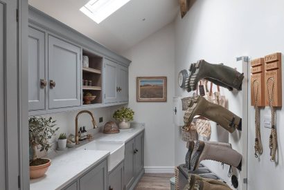 A utility room with boot stand at Beatrix Cottage, Lake District
