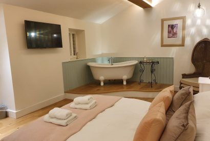 The bedroom with free standing bath at Twitchers Cottage, Lake District