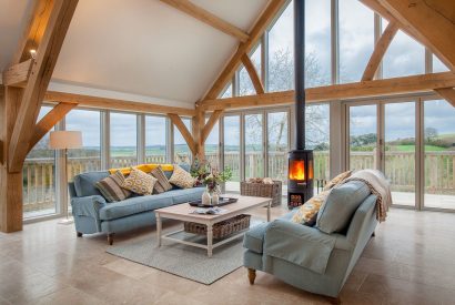 The living room with a log burner at Serenity Retreat, Devon