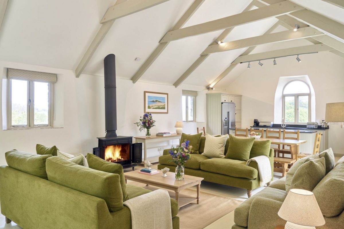 The living room with log burner at Fern House, Devon