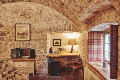 The desk area and exposed brick walls at Fritillaria Cottage, Vale of Glamorgan