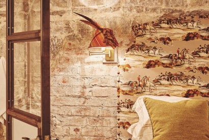 Bedroom accessories against the exposed brick walls at Fritillaria Cottage, Vale of Glamorgan