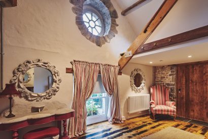 Rustic features of a king-size bedroom at Lotus Cottage, Vale of Glamorgan