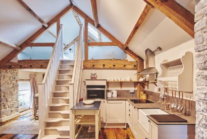 The kitchen and staircase to the mezzanine level at Lotus Cottage, Vale of Glamorgan