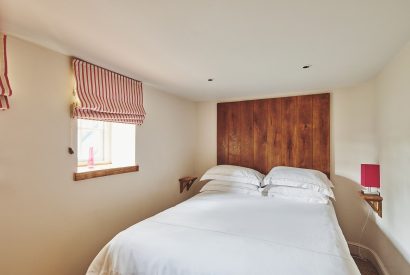 A king-size bedroom at Lotus Cottage, Vale of Glamorgan