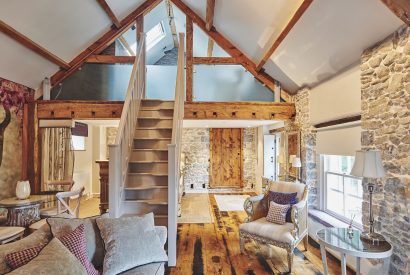 The open-plan living space and staircase at Hollyhock Cottage, Vale of Glamorgan