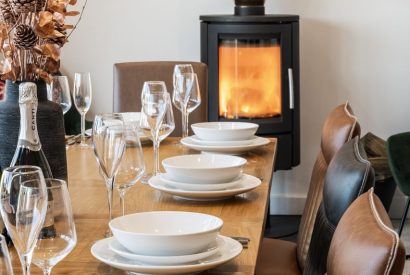 The dining room with log burner at Porthleven View, Cornwall