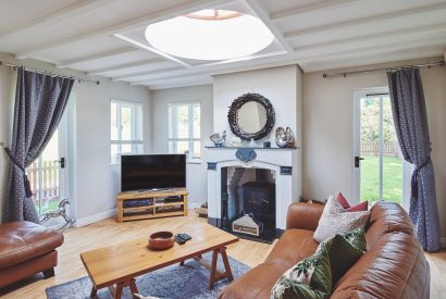 The living room with a log burner at Osborne Lodge, Herefordshire