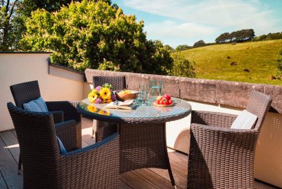 The private patio with an outdoor dining table at Dartington Cottage, Devon