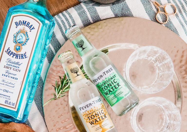 Bottles of Bombay Sapphire and tonic on a tablecloth