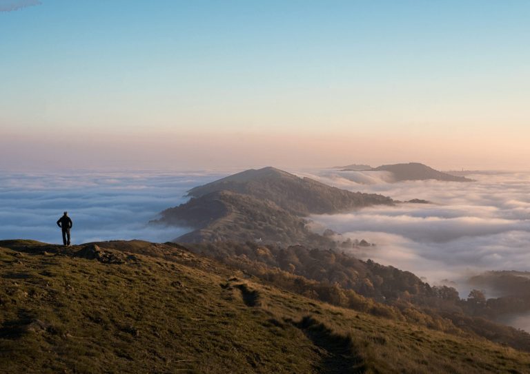 A person walking the Malvern Hills on a cloudy day