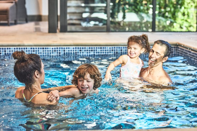 Couple enjoying a swimming pool on a luxury cottage holiday