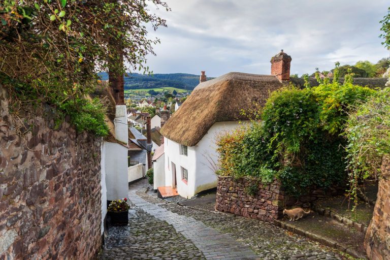 Winding cobbled street with thatched cottage in the town of Minehead