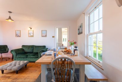 The dining and living space at Millook View Farmhouse, Cornwall