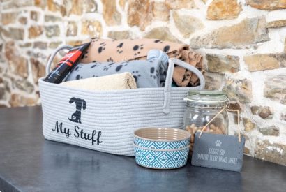 A basket of dog blankets and toys at Millook View Farmhouse, Cornwall