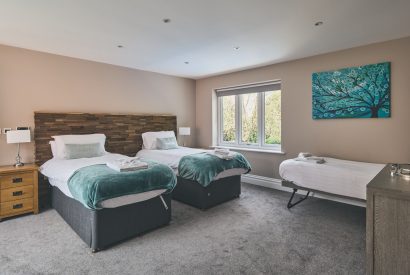 A bedroom with two single beds at Sharnbrook Retreat, Bedfordshire
