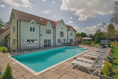 The back exterior and swimming pool at Sharnbrook Retreat, Bedfordshire