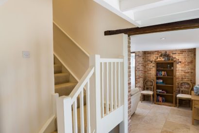 The hallway with the wooden stair case at Brightwaters Stables, Hampshire