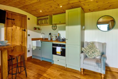 The kitchen and breakfast bar at Abberley Shepherd's Hut, Worcestershire