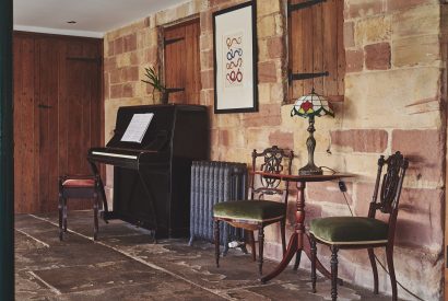 The piano in the sunroom at Heron House, Peak District