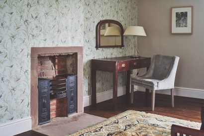 An open fireplace in the bedroom at Heron House, Peak District