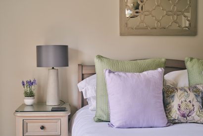 The bed and side table at Bay Tree Cottage, Cotswolds