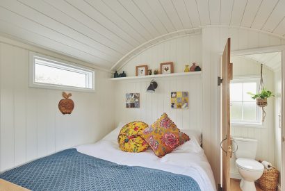 The king-size bed and view of the en-suite at Windmill Old Orchard, Somerset