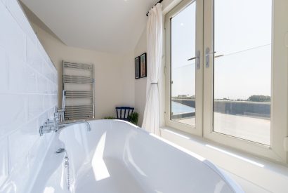 A bathroom which overlooks the sea view at Minack View, Cornwall